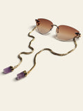 The Capri - rimless cat-eye sunglasses in gold with brown gradient lenses, three-quarter view, gold box chain draped to two raw purple quartz stones