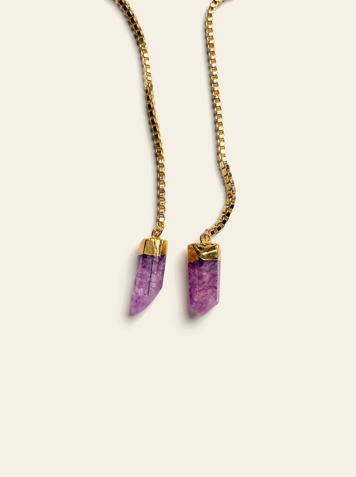 The Positano - close-up of two raw purple quartz points hand-set in gold caps on a gold box chain