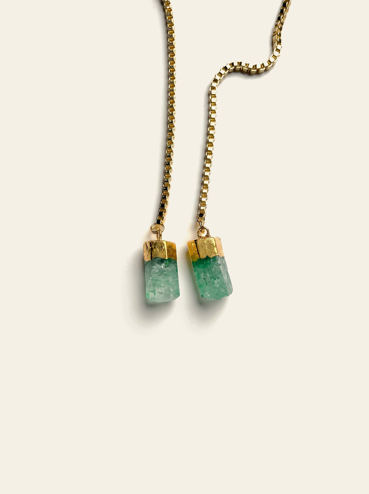 The Ravello - close-up of two raw sea-green quartz stones hand-set in gold-dipped caps on a gold box chain