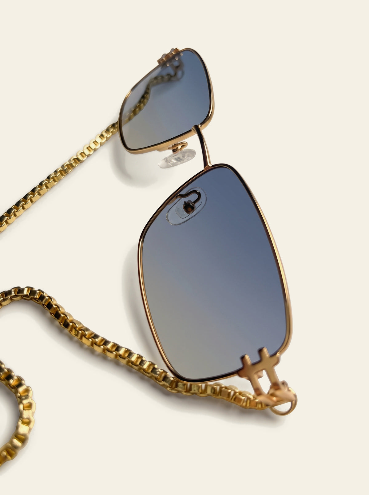 The Ravello - close-up of the thin gold rim and blue-grey gradient lens fading from slate blue to a pale haze