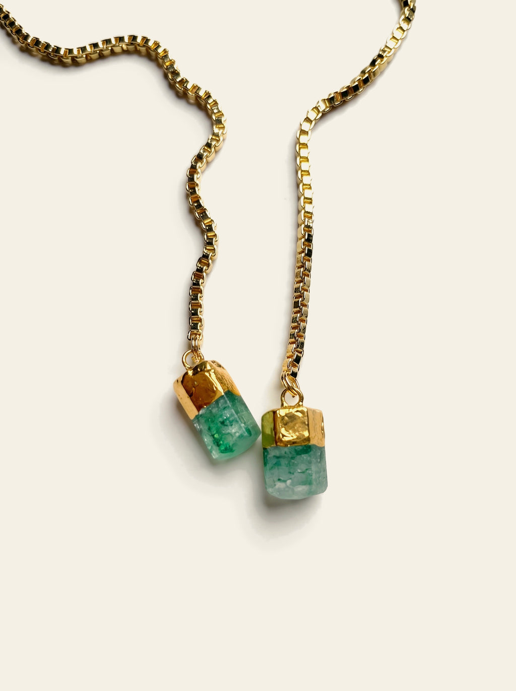 The Sorrento - close-up of two raw green quartz stones hand-set in gold-dipped caps on an 18K gold-plated box chain