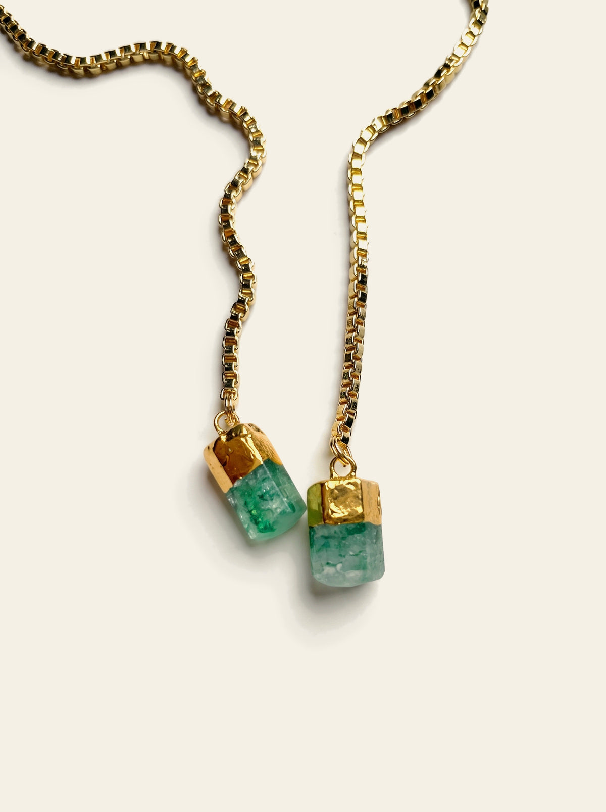 The Sorrento - close-up of two raw green quartz stones hand-set in gold-dipped caps on an 18K gold-plated box chain