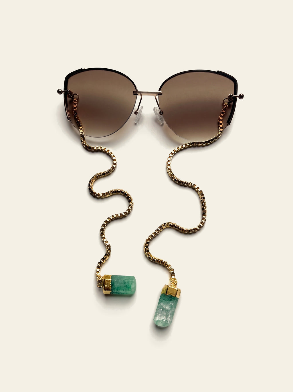 The Cannes - top view of gold semi-rimless butterfly sunglasses with brown gradient lenses and 18K gold-plated box chain
