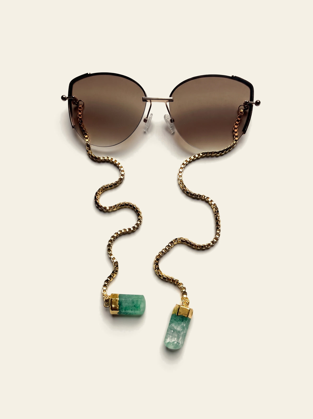 The Cannes - top view of gold semi-rimless butterfly sunglasses with brown gradient lenses and 18K gold-plated box chain