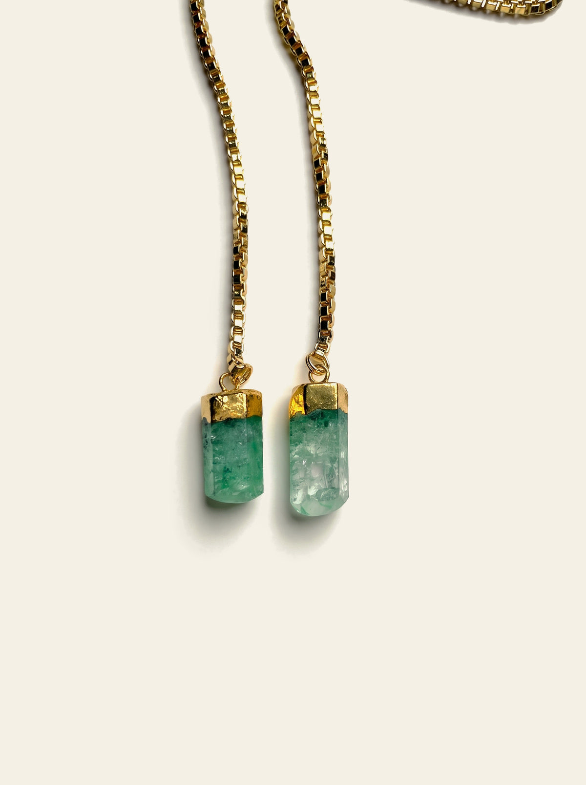 The Cannes - close-up of two raw green quartz stones hand-set in 18K gold-plated caps on gold box chain