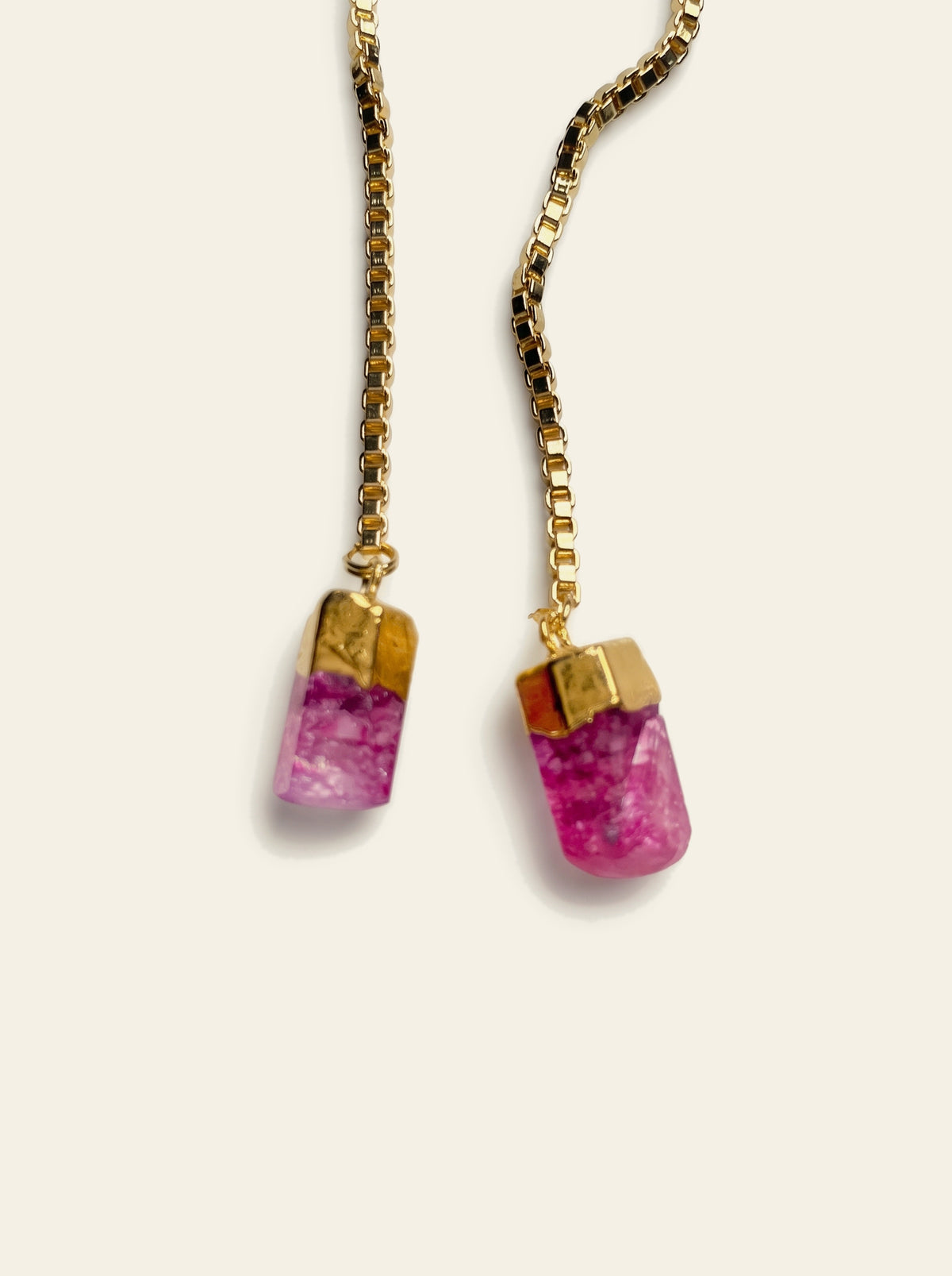 The Monaco - close-up of two raw pink quartz stones hand-set in gold caps on the 18K gold-plated box chain