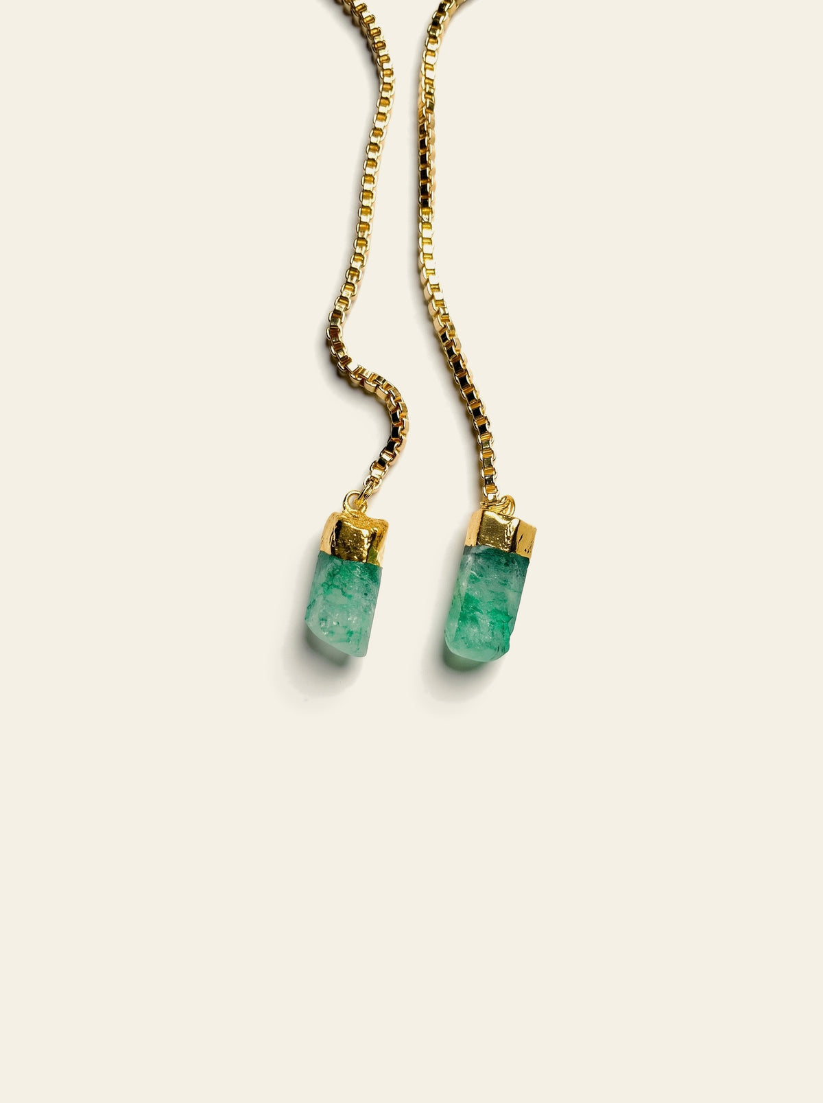 The Marbella - close-up of two raw green quartz stones hand-set in gold-dipped caps on an 18K gold-plated box chain