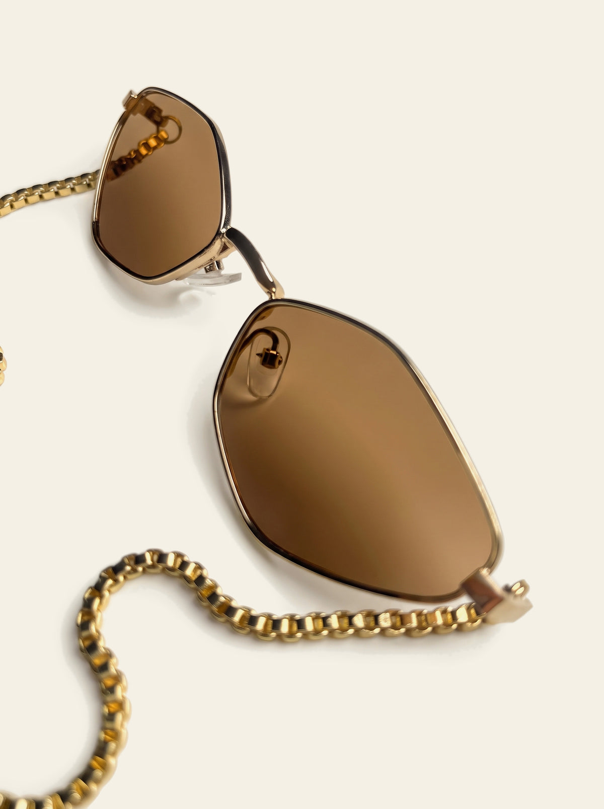 The Cassis - close-up of the fine gold hexagon rim and solid brown polycarbonate lens