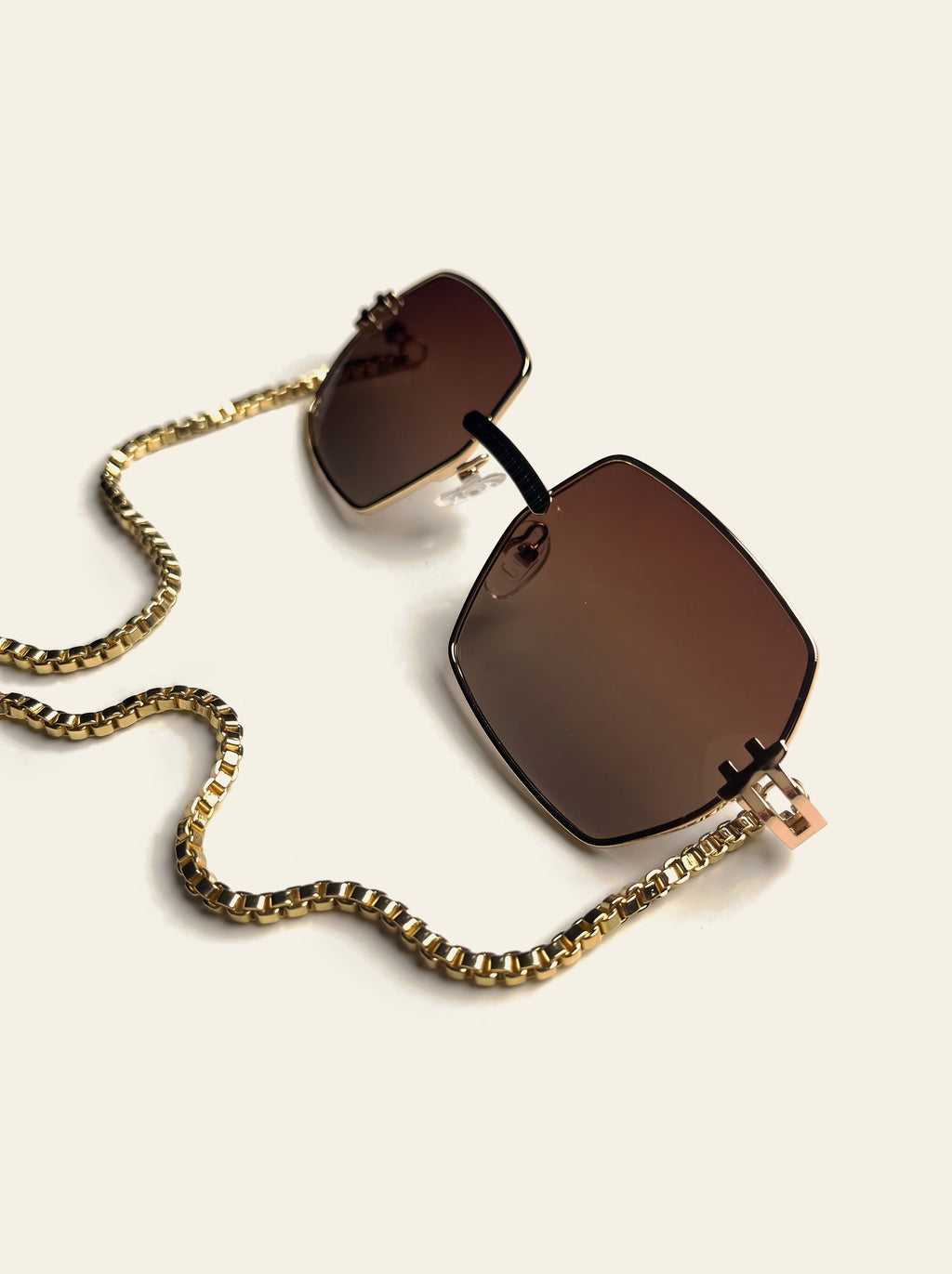The Santorini - close-up of the rimless square brown gradient lenses and slim gold fittings