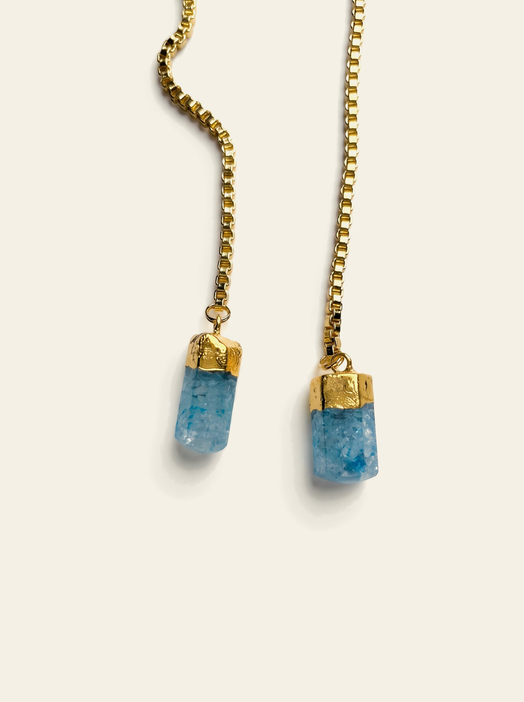 The Sardinia - close-up of two raw pale blue quartz stones hand-set in gold caps on an 18K gold-plated box chain