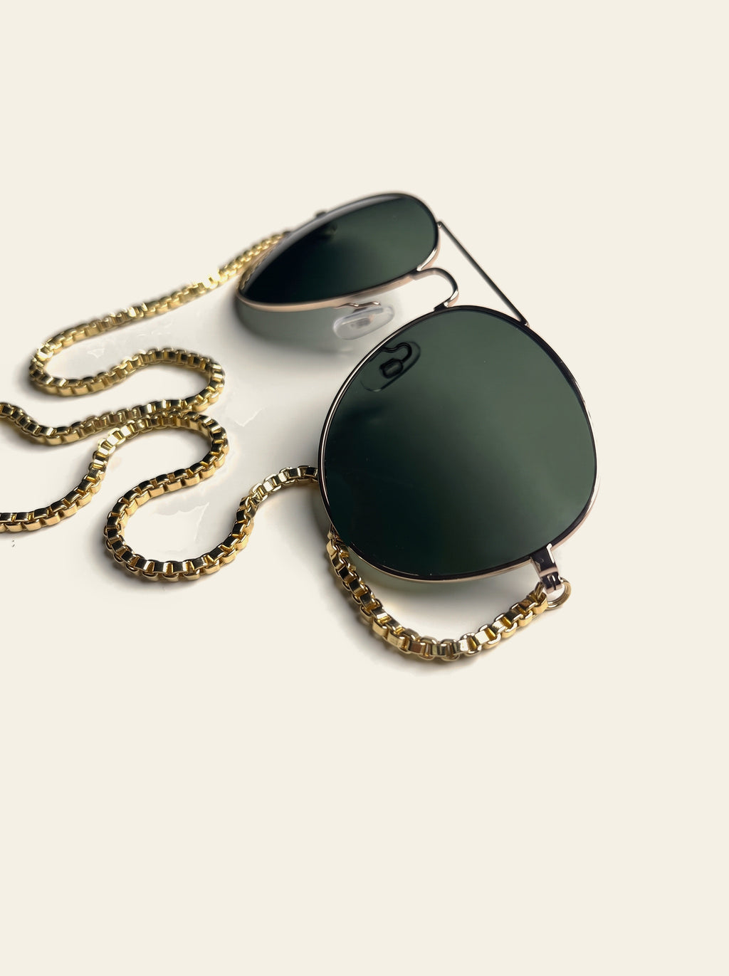The Saint-Tropez - front view of gold double-bridge aviator sunglasses with dark green lenses and gold chain