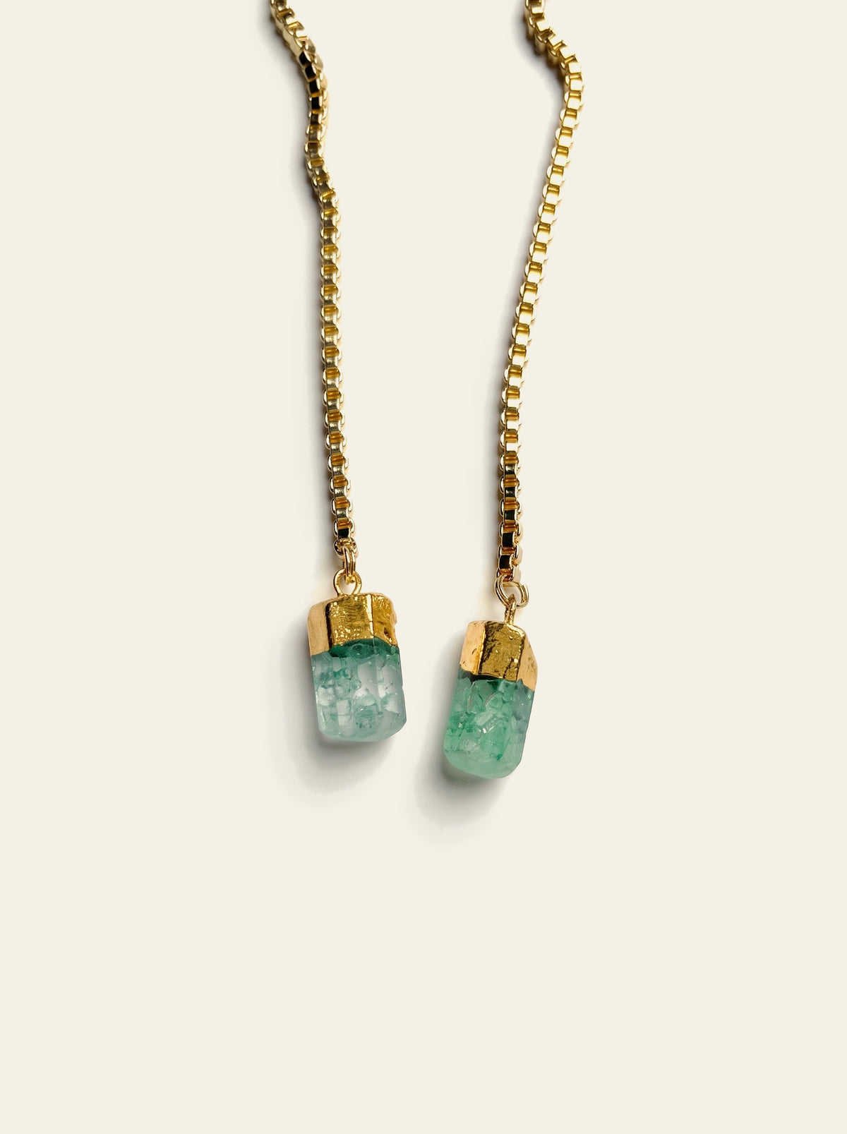The Saint-Tropez - close-up of two raw mint green quartz stones hand-set in gold-dipped caps on a gold box chain