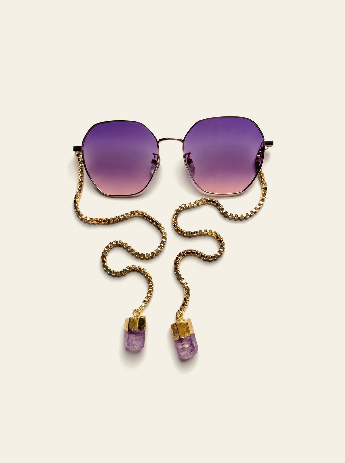 The Lipari - top view of gold hexagon frame showing the purple-pink gradient lenses and 18K gold-plated box chain