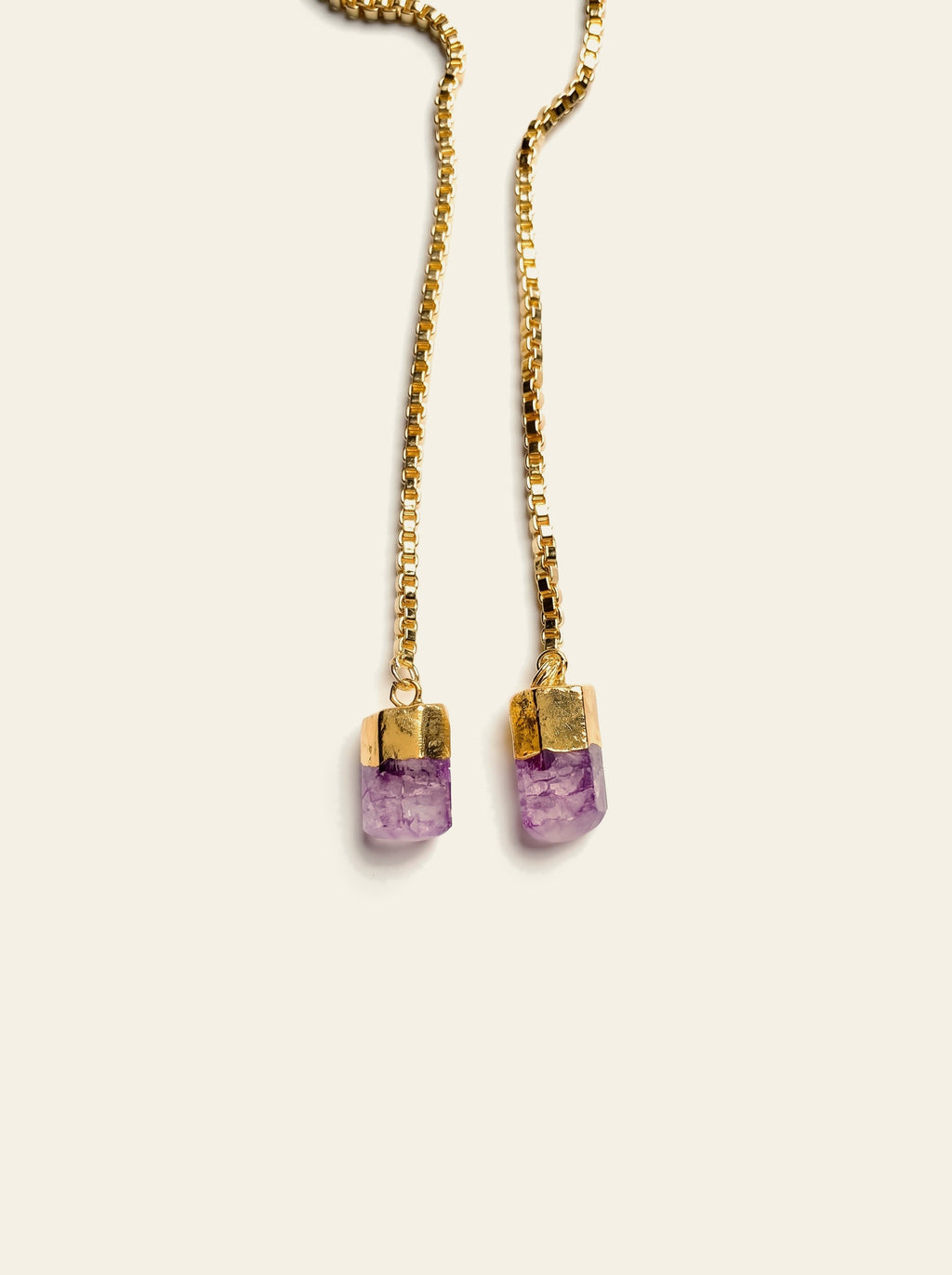 The Lipari - close-up of two raw purple quartz stones hand-set in gold-plated caps on the gold box chain